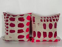 Front view of both pillows showing paint pattern