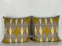 Front view of both geometric patterned pillows