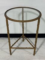 full view of table showing glass top and bamboo-style metal frame