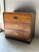 Front and side view of dresser showing three drawers and brass hardware
