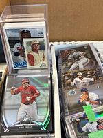 Stacks of top-loaded cards; visible Mike Trout Bowman card and other rookies