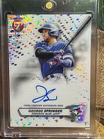 Front of 2023 Topps Pristine George Springer autograph card showing holographic refractor surface and signature