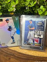 Both Pete Alonso rookie cards in protective sleeves