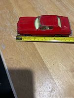 Side and top view showing overall condition and tape measure indicating length (~6.25")