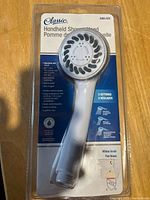 Front of sealed Classic handheld shower head package showing product, model 3265-072, 3 settings, white finish