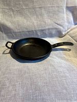 Top view of Lodge cast iron skillet showing cooking surface and dual handles