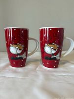 Front view of both matching red Claus mugs