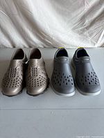 Both pairs of rubber slip-on shoes side by side