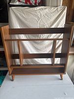 Front view of wooden bookshelf showing compartments and legs
