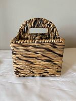 Front view of square wicker basket showing woven pattern and handle