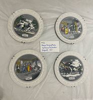 Front view of four decorative Doctor Syntax plates with embossed borders