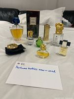 Front view of all perfume bottles, minis, boxed Chanel bath gel and compact