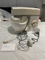 Mixer front view with bowl and three attachments