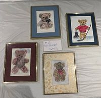 Front view showing all four framed teddy bear watercolors with different mats