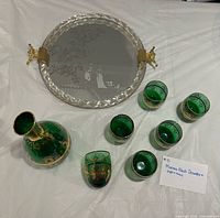 Full view of decanter, six cordial glasses and round mirrored tray