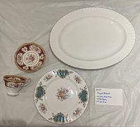 Platter, plate, teacup and saucer arranged on surface