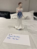Front view of Royal Doulton figurine standing on table
