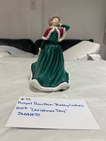 Front view of porcelain figurine standing on table