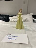 Front view of Royal Doulton Capricorn figurine on table