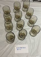 All 12 smoke grey wine glasses arranged on table