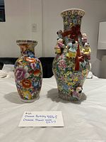 Both Chinese porcelain vases side by side on table