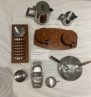 Full layout of teak and stainless steel breakfast/tea serving pieces