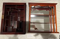 Front view of both curio cabinets showing compartment layout and mirrored shelves