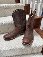 Full view of both boots on staircase showing overall condition and style