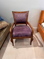 Front view of wood armchair showing purple microsuede seat and back
