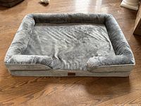 Full view of grey Bedsure orthopedic dog bed showing bolstered sides and sleeping surface