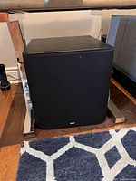 Front view of B&W ASW 600 subwoofer under table