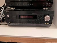 Front view showing Integra branding, model label, display window, volume knob and front controls