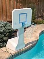 Full view of poolside basketball hoop beside pool