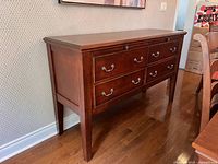 Three‐quarter view of full sideboard showing six drawers and legs