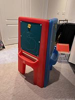 Rear view of red side showing chalkboard panel, clip, lower storage slot