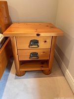 front view of nightstand showing two drawers, handles, and lower shelf