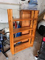 Front/side view of wooden log-style bookcase, four shelves