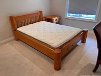 Full view of bed frame with mattress showing headboard, side rails, posts
