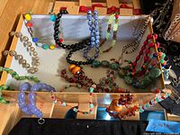 Tray showing assortment of beaded necklaces