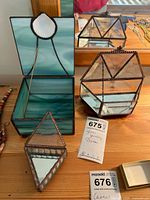 All three glass boxes: open green square box, clear hexagonal box, clear triangular prism box