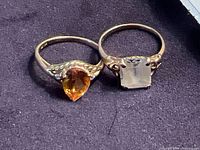 Both 10K gold rings side by side showing gemstones and settings