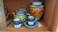Overall lot showing teapot, vase, cups, saucers, plate