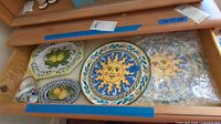 Drawer view showing two sun platters, lemon tray, oval tray, small dish, teacups