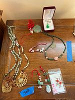 Assorted jade jewelry including necklaces, pendants, earrings, bracelet and charms
