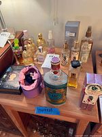 Overview of lot showing multiple perfume bottles and boxes