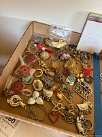 Full box showing variety of pins and brooches