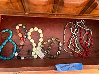Drawer view showing all ten polished stone necklaces