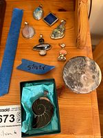 Group of pendants, ammonite in box, stone dish