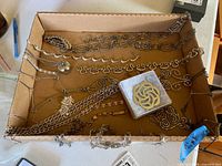 Tray overview showing multiple necklaces, pendants, bracelets and earrings