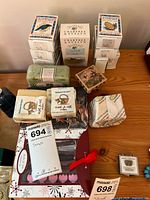 Overview of assorted boxed and wrapped soaps on table